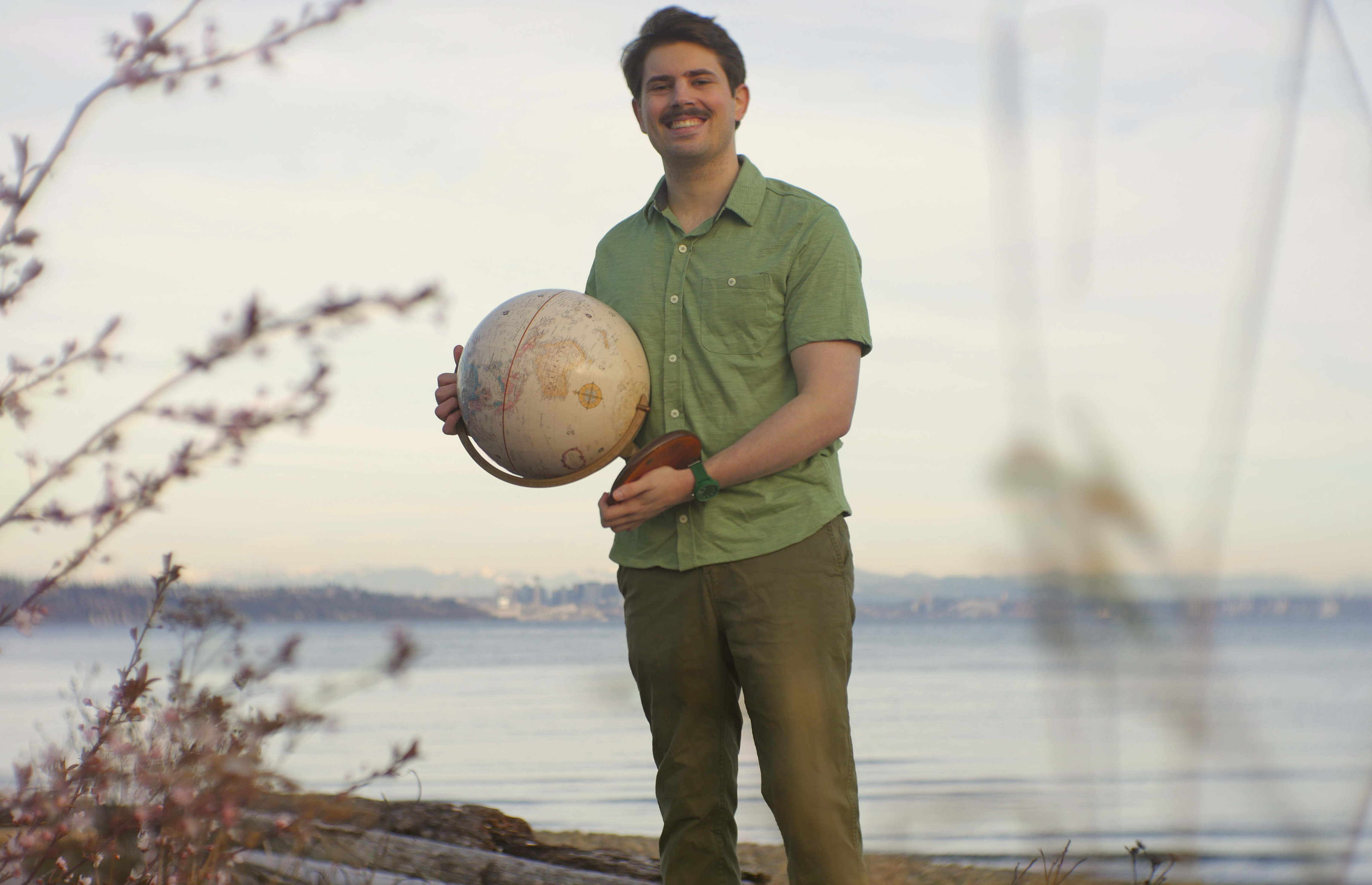 Kyle holding a globe.